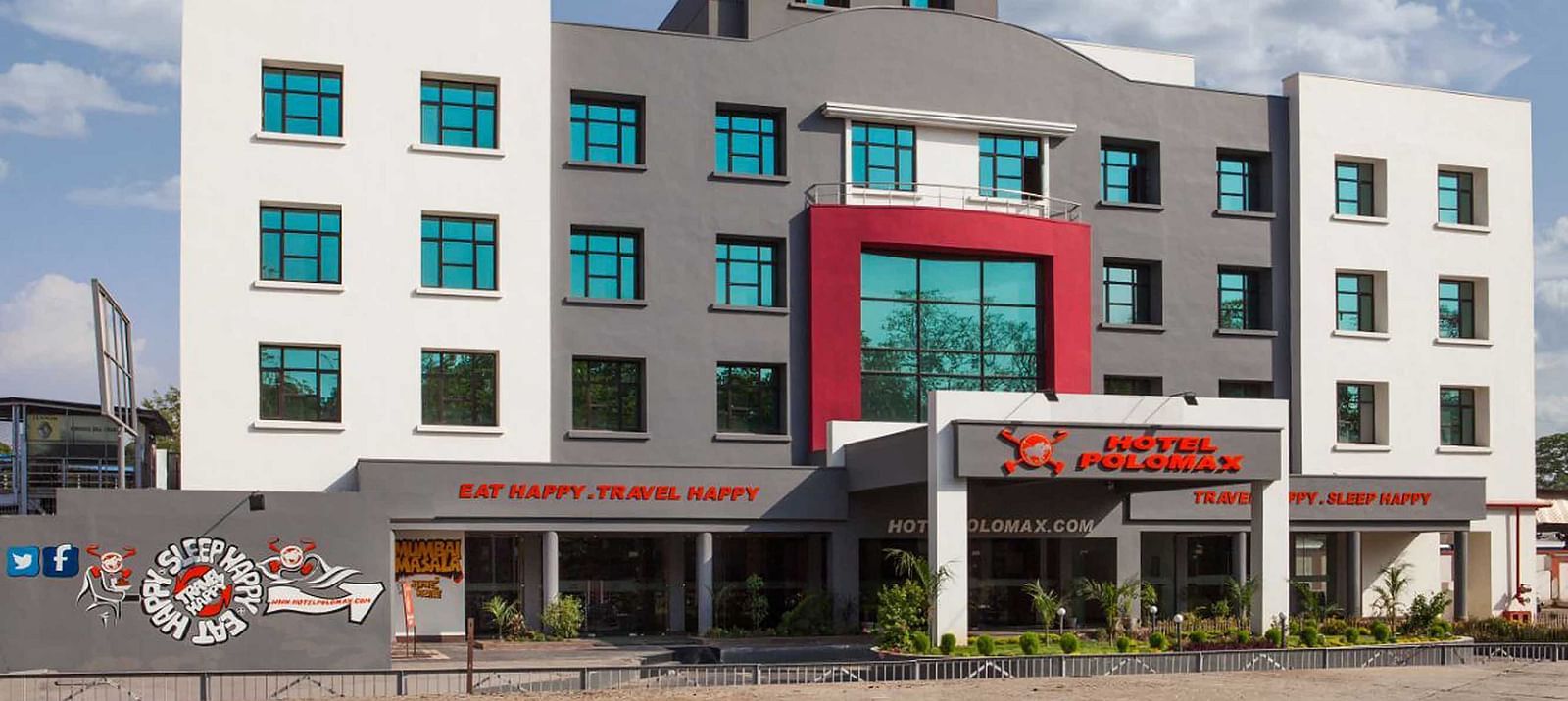 facade image of our hotel taken on a bright sunny day with cloudy blue skies in the background - Max Hotel Jabalpur