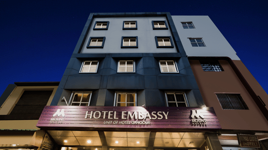 Mount Embassy Hotel in Siliguri with illuminated signage and structured facade.