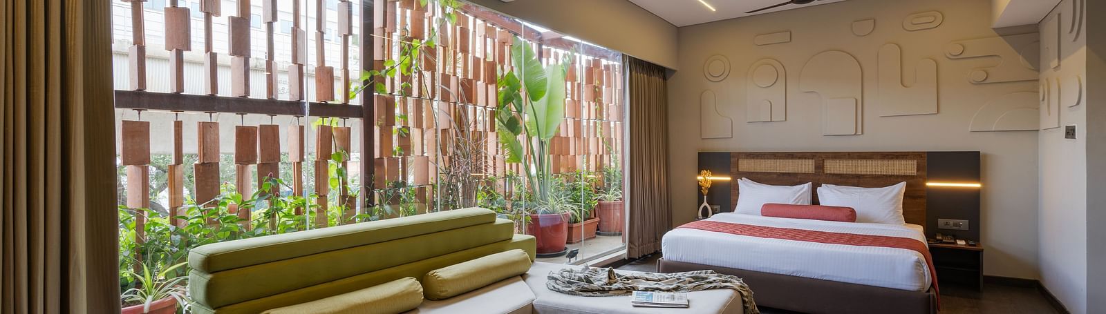 Comfortable Room with ample sunlight and a plush bed. The room aslo features a relaxing six seater sofa, perfect for both business and leisure travelers.