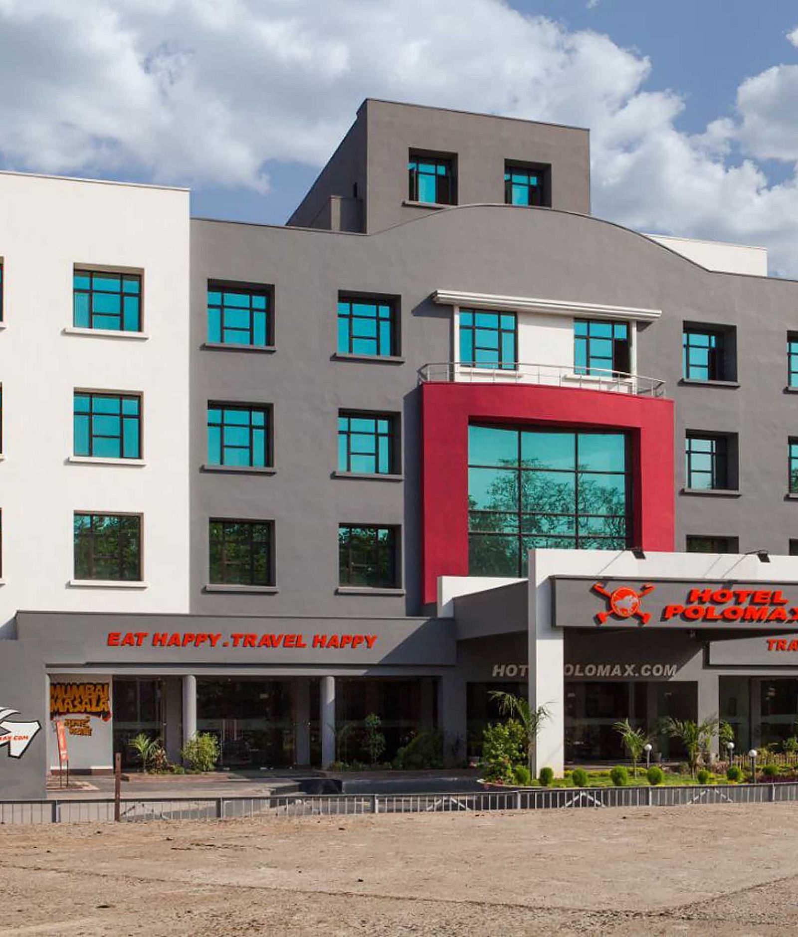 Exterior of Max Hotel Jabalpur on a sunny day with scattered clouds.