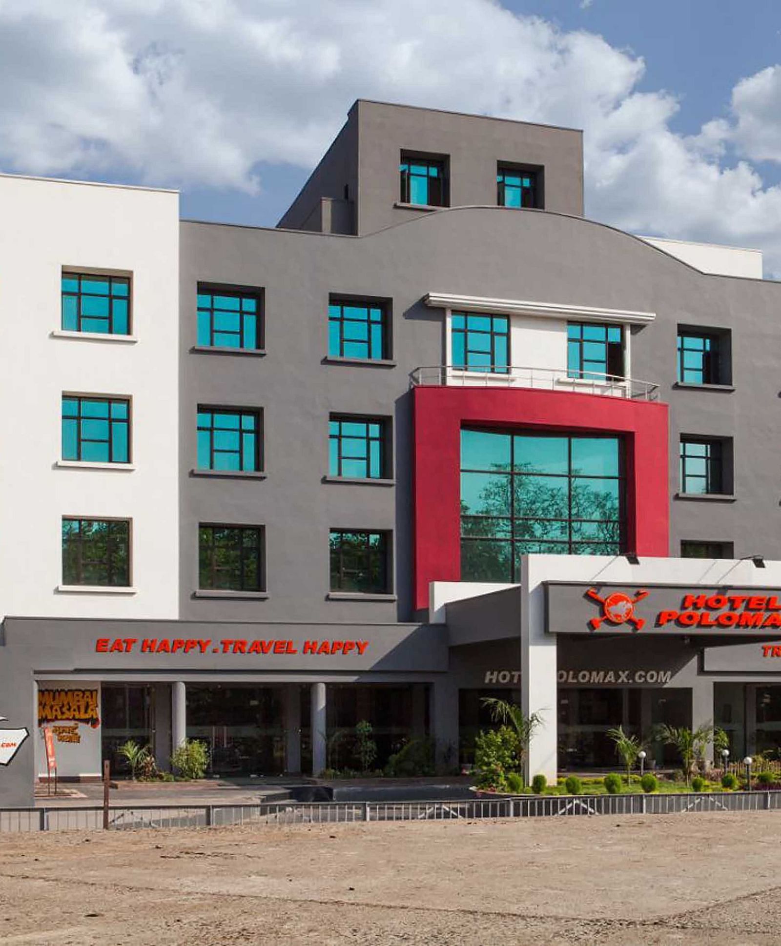 Exterior of Max Hotel Jabalpur on a sunny day with scattered clouds.