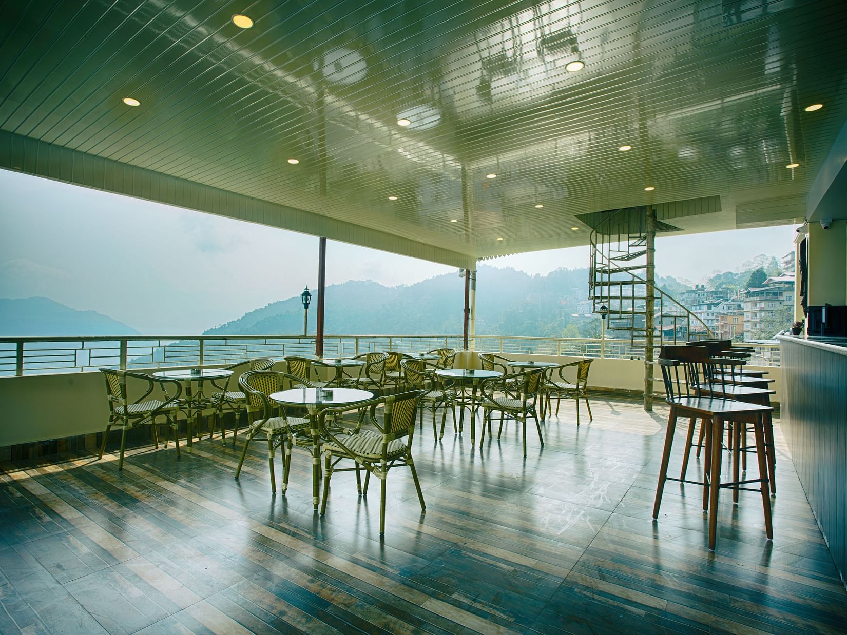 full view of Sky bar lounge captured during the day showcasing the kanchenjunga hills - the aryan regency
