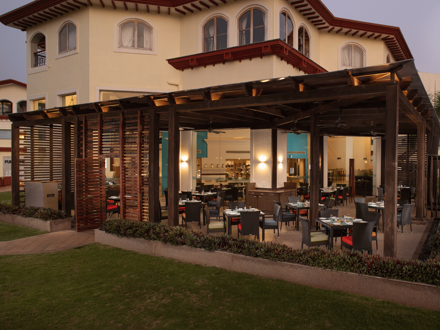 Elegant outdoor dining at Palms Restaurant, Kenilworth Resort & Spa, Goa - a premier 5-star resort in South Goa.