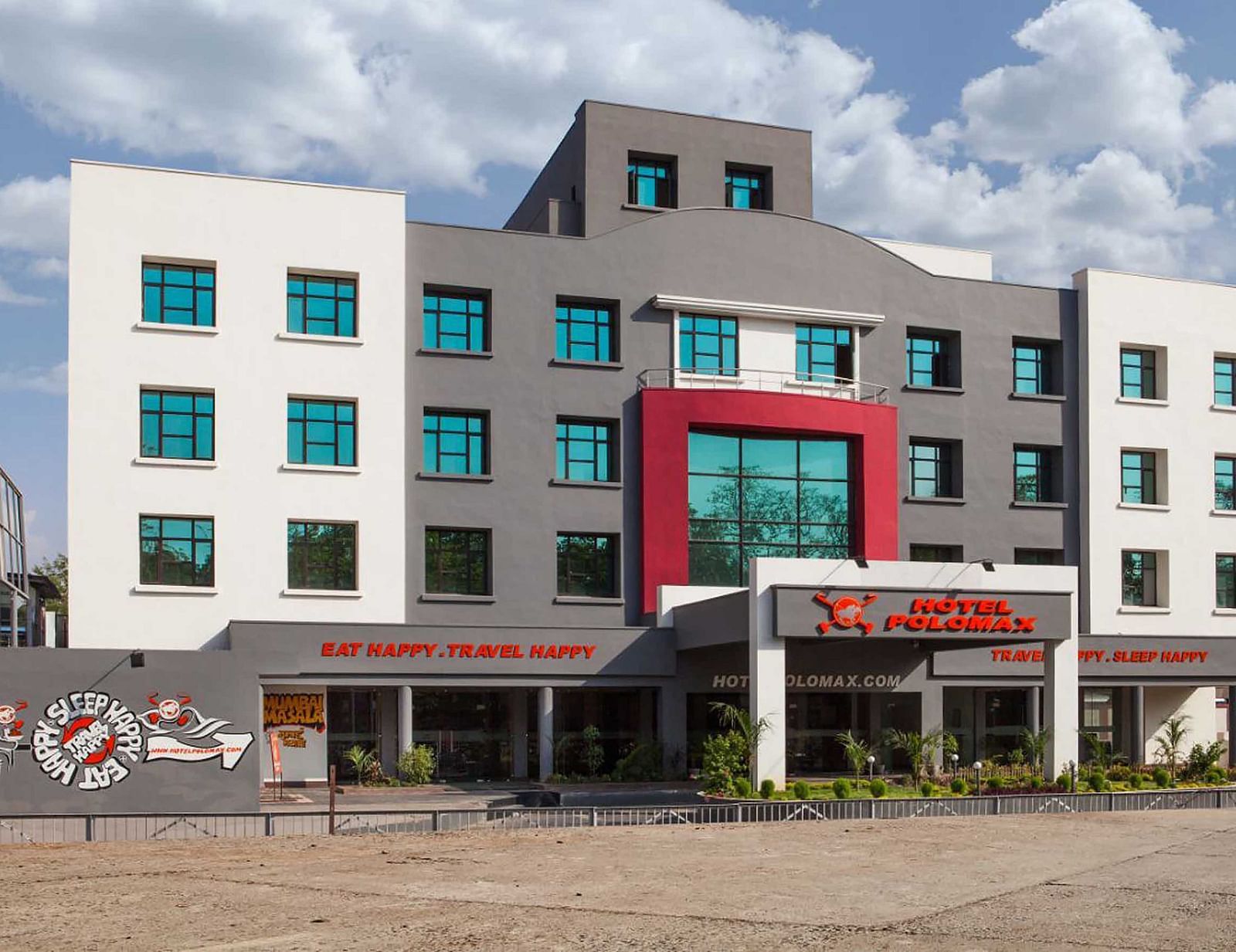 facade image of our hotel taken on a bright sunny day with cloudy blue skies in the background - Max Hotel Jabalpur