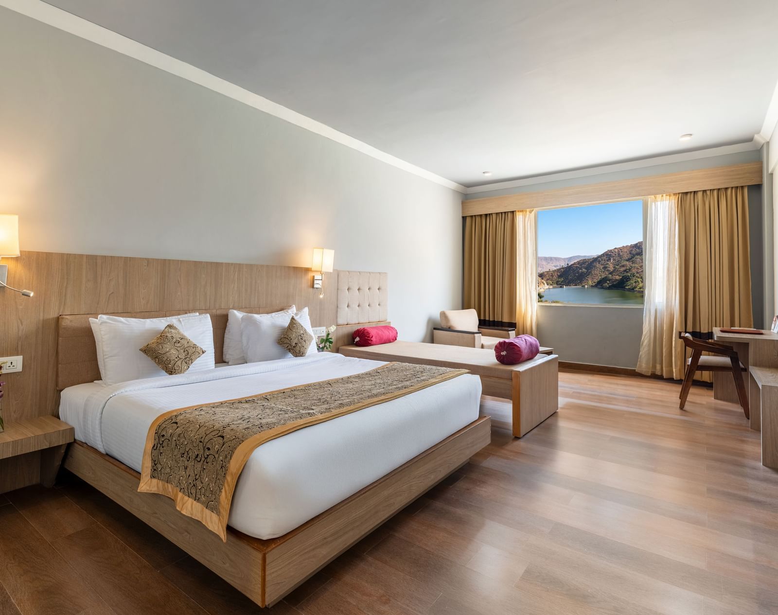 A wide angle shot of a room with a large bed neatly arranged with a patterned runner on it - Via Lakhela Resort & Spa, Kumbhalgarh