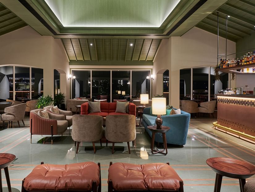 Bar seating area with stylish stools and a well-stocked bar in a modern setting at The Dukes Retreat