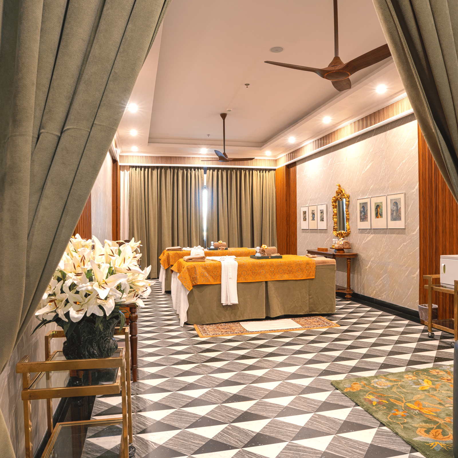 A spacious lounge area with patterned flooring, soft seating, draped curtains, potted plants and warm lighting, creating a stylish indoor relaxation zone at MAYFAIR Bay Resort, Paradeep.