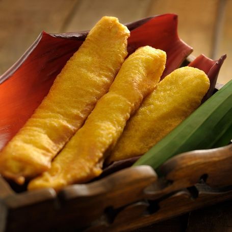 Pazham Pori (banana fritters) with chai on a rustic table.