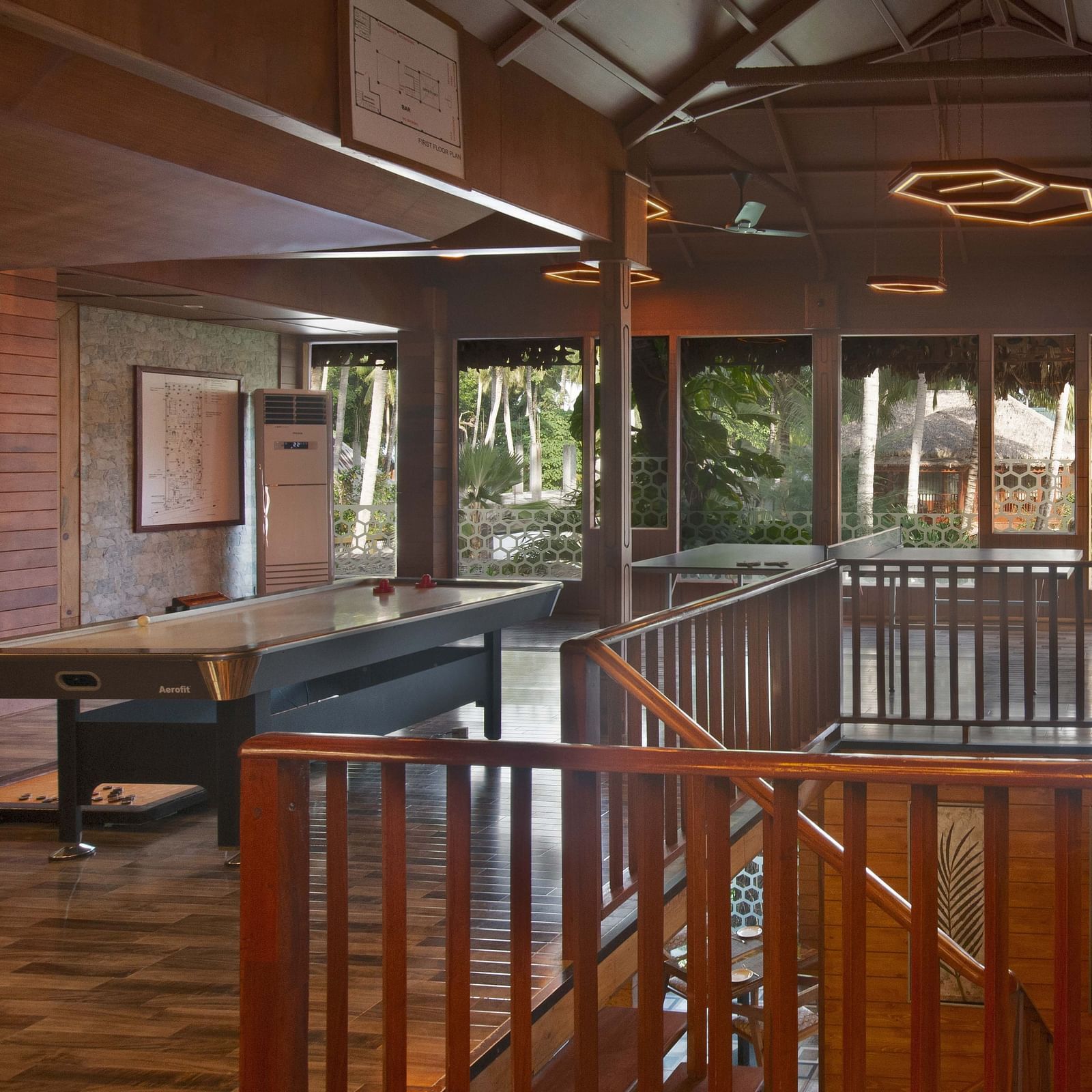 A well-designed interior with a staircase and elegant wooden railings. The natural light streaming through the windows adds to the open and airy feeling of the space - Coral Reef Resort & Spa, Havelock