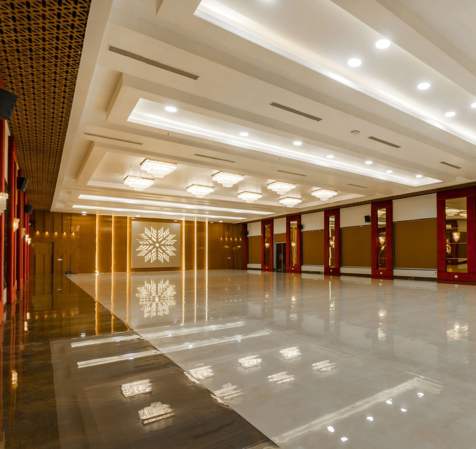 An angular shot of a long, empty hallway with a highly polished floor reflecting the ceiling and walls - Bamboo Saa Mulberry Resort, Pushkar