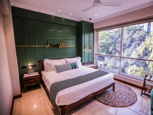 bedroom with modern interior and expansive window overlooking the city