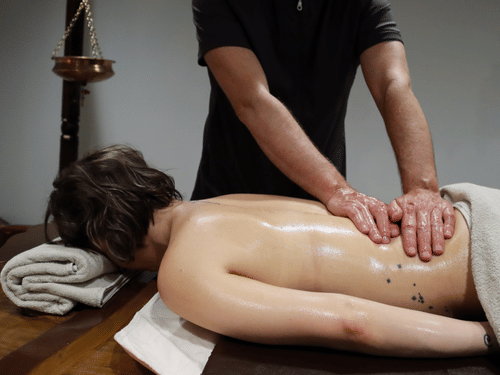A guest receives a traditional Ayurvedic full-body oil massage at YO1 Longevity & Health Resorts, where holistic therapies promote relaxation, balance, stress relief, and overall well-being.