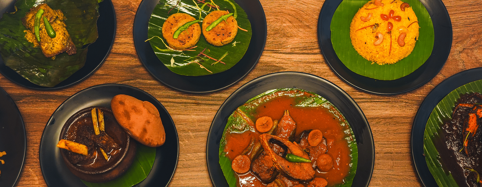 a wide spread of authentic bengali cuisine featuring various dishes on the table - Dip Holidays, Birbhum