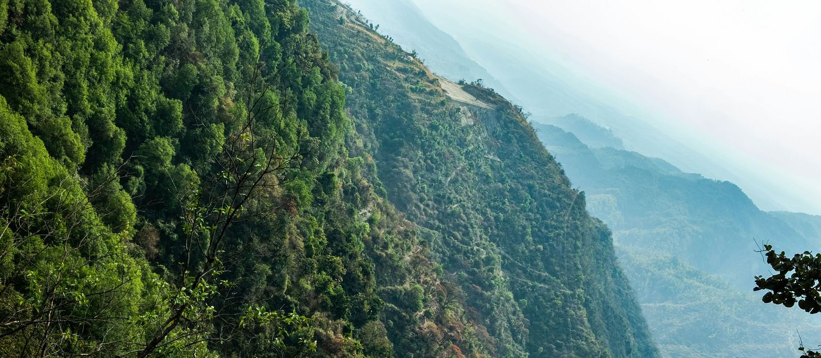 a scenic view of a mountain with a valley in the distance