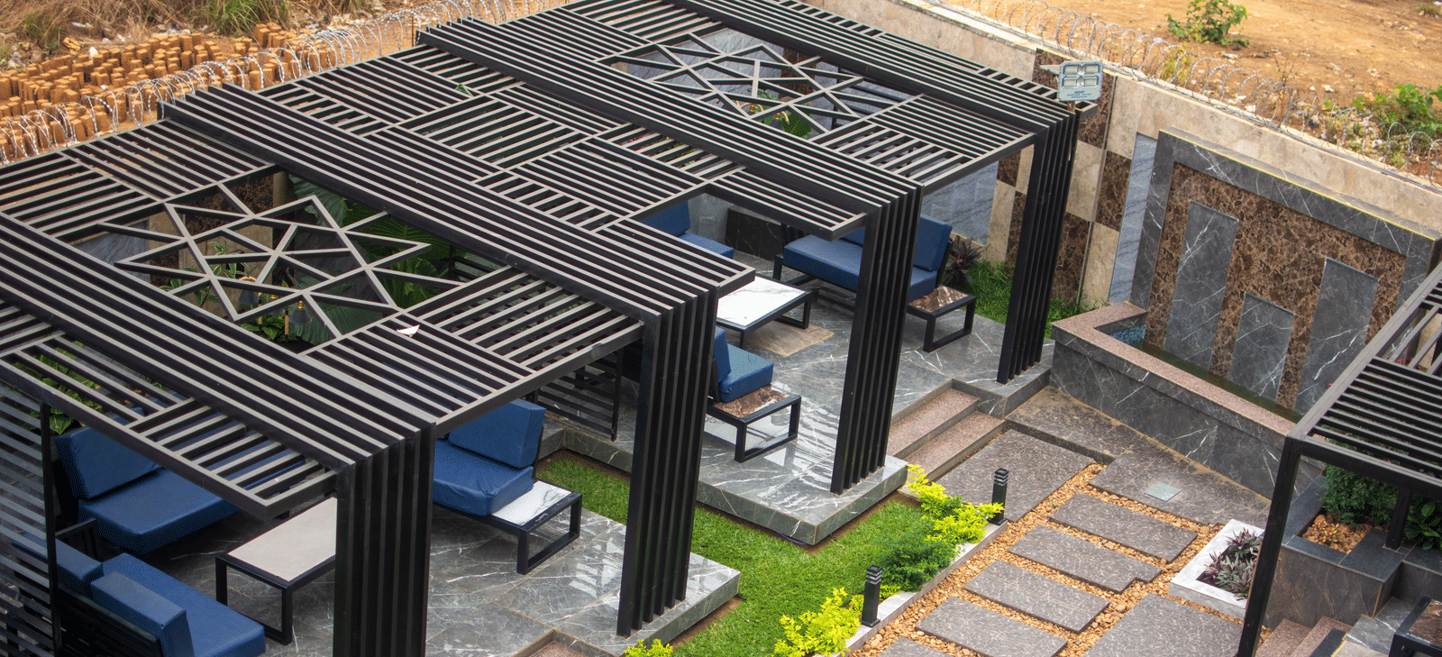Outdoor seating area with covered pergolas on a paved patio - Luffu Club
