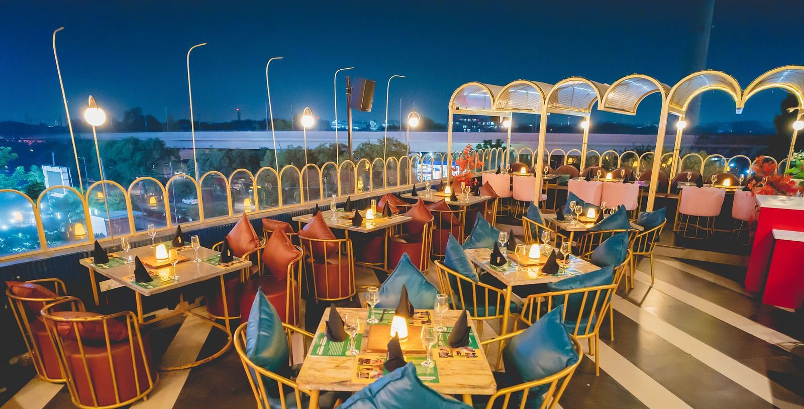 An image of a seating area on the rooftop of Themis Barbecue House with tables and chairs