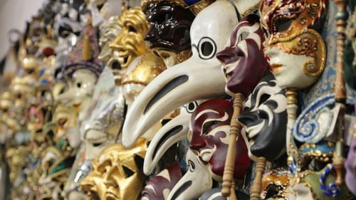 Decorative masks with exaggerated features displayed in an artistic setting at Heritage Village Resorts & Spa, Goa.