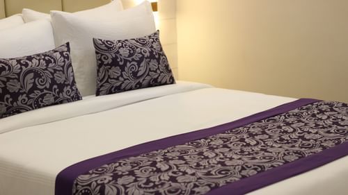 Queen bed in Deluxe Room at Pride Biznotel Canopus Digha