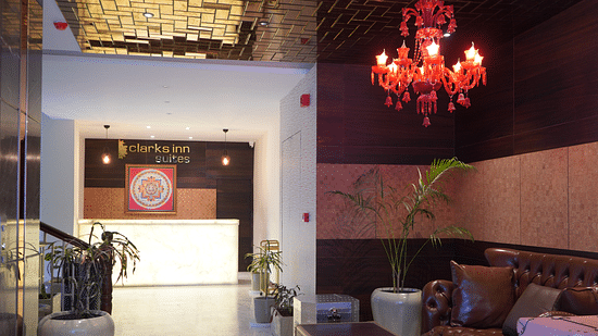 Lobby featuring a reception desk and sitting space above which a chandelier is hanging