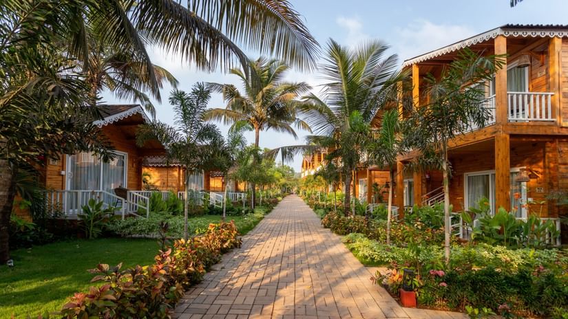 a path surrounded by villas and greenery at Aralea Beach Resort by Stone Wood, Morjim