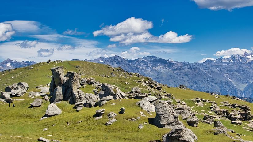 a plain with rocks beneath a cloudy sky