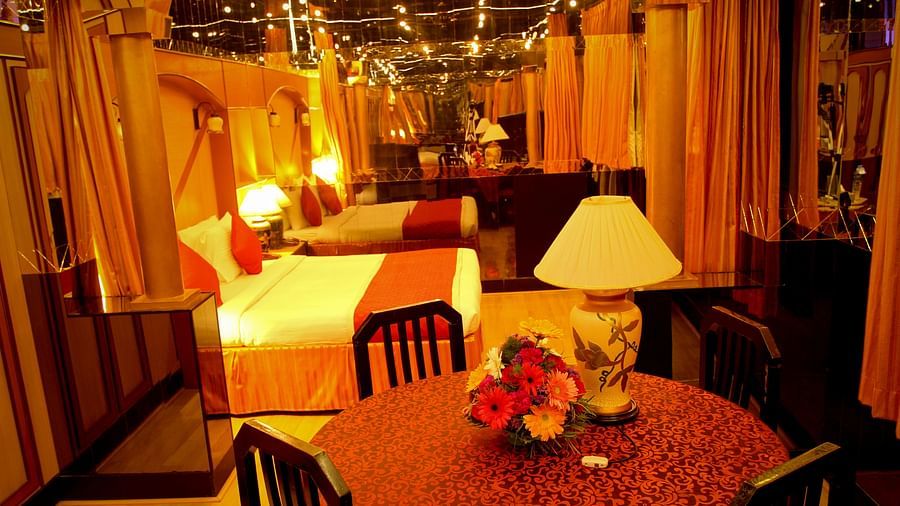  Hotel Yasodha Towers - Interior view of a bedroom featuring a table containing a lamp and two single beds seen in the background 