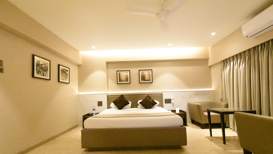 Spacious deluxe room with a double bed and modern interiors at Kings International Juhu