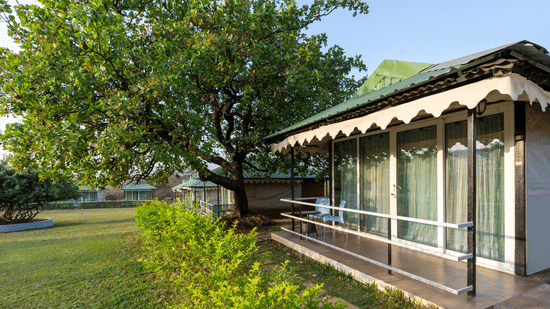 Colonial-style building with a long porch and green surroundings at Nature Trails Durshet