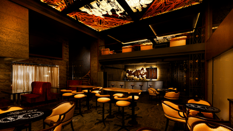 A stylish dining space with warm lighting, plush seating, and elegant tables at a restaurant in T Nagar Chennai - Grand Chennai by GRT Hotels