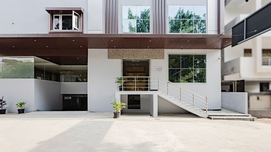 Front view of the spacious driveway and main entrance at Lemonridge Hotels, IDPL Balanagar, captured during daytime.