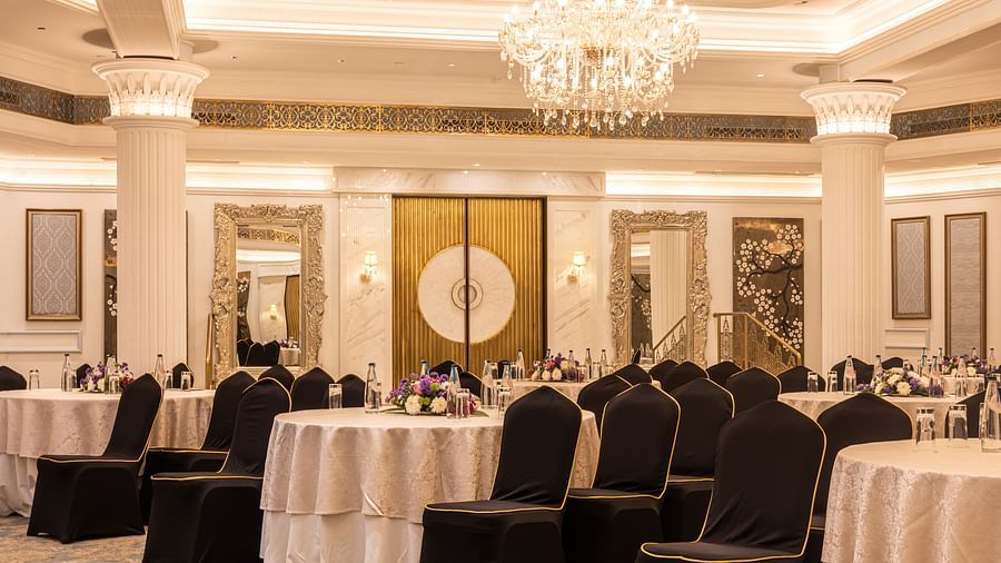 Image featuring the Viceroy Hall event venue at The Claridges New Delhi, showcasing seating arrangements and an elegant chandelier hanging overhead