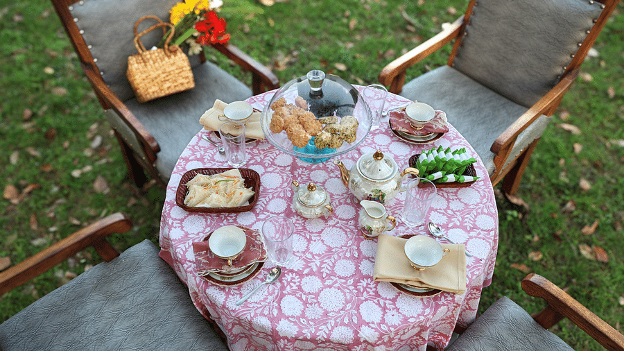 A top-angle view of the breakfast table surrounded by chairs placed in an open-air setting during the day at The Sylvan Retreat, Dehradun.