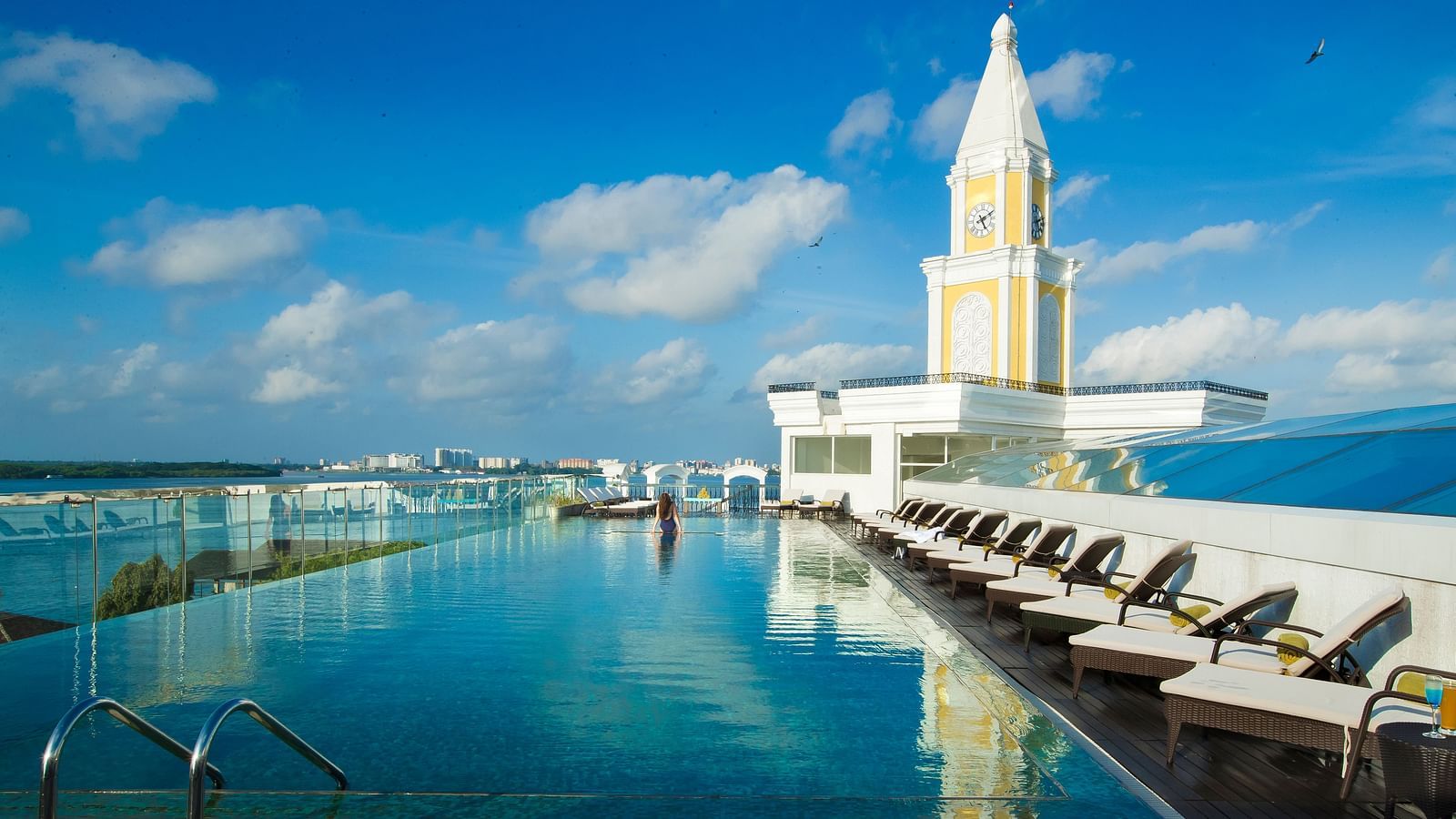 Swimming pool with a view aligning the sky and beach