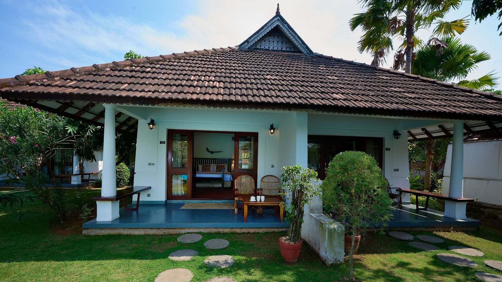 exterior image of a room in front of a garden - Rhythm Kumarakom