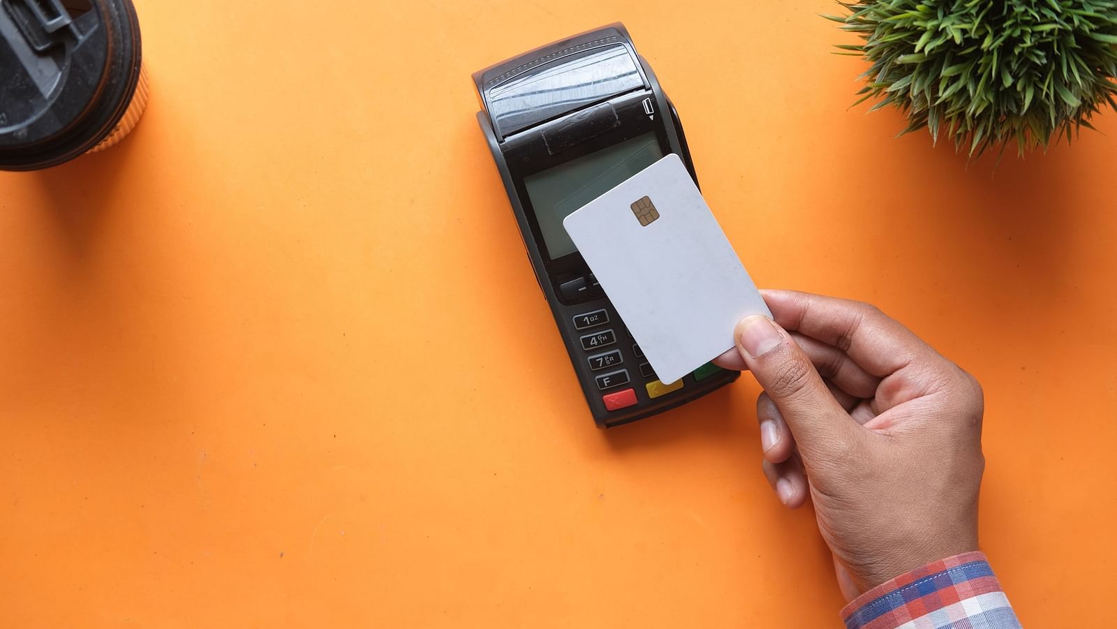 a person making a Credit card payment on the machine
