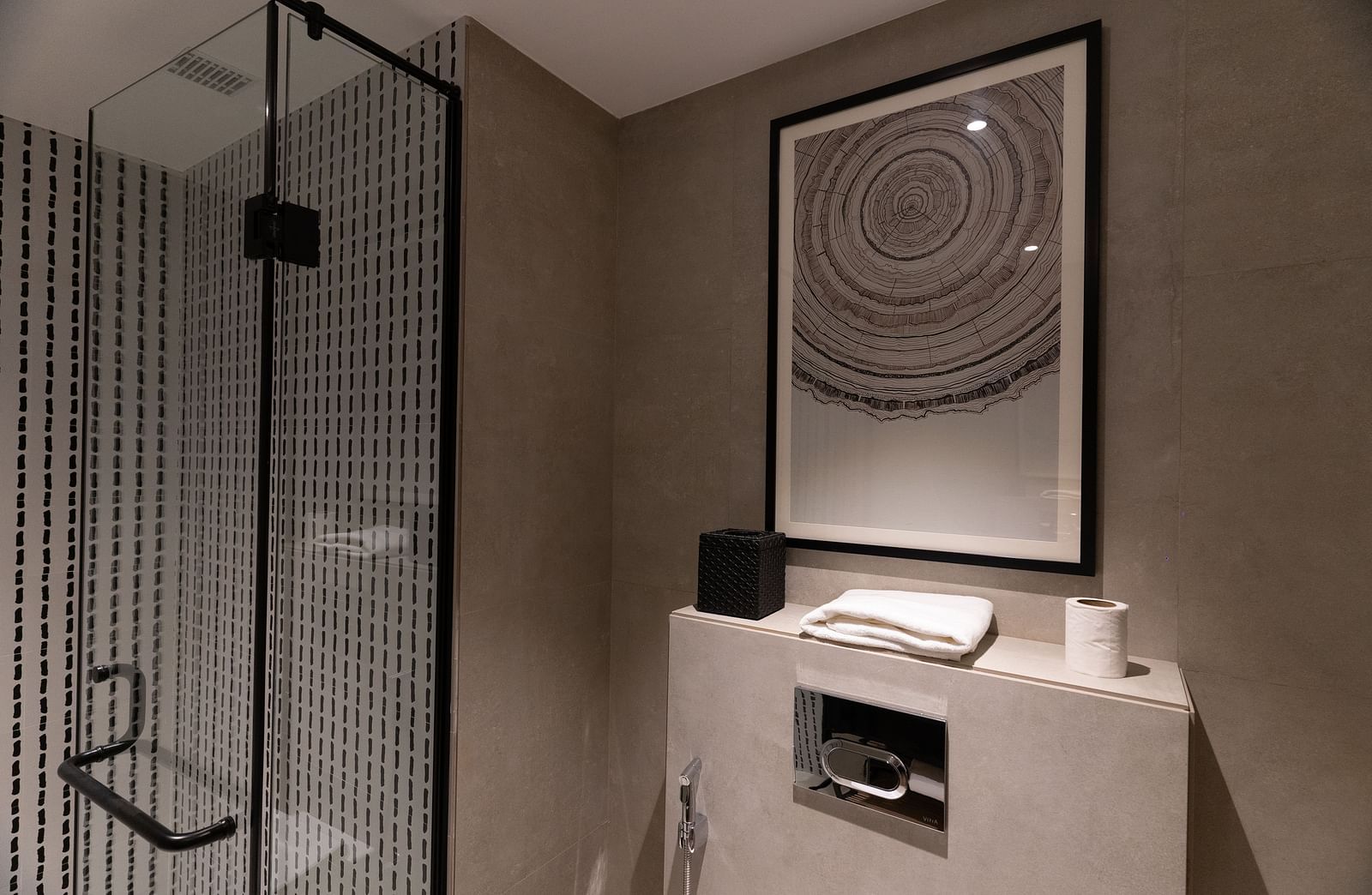 Compact bathroom with a toilet and framed artwork at Nivasana Manali.
