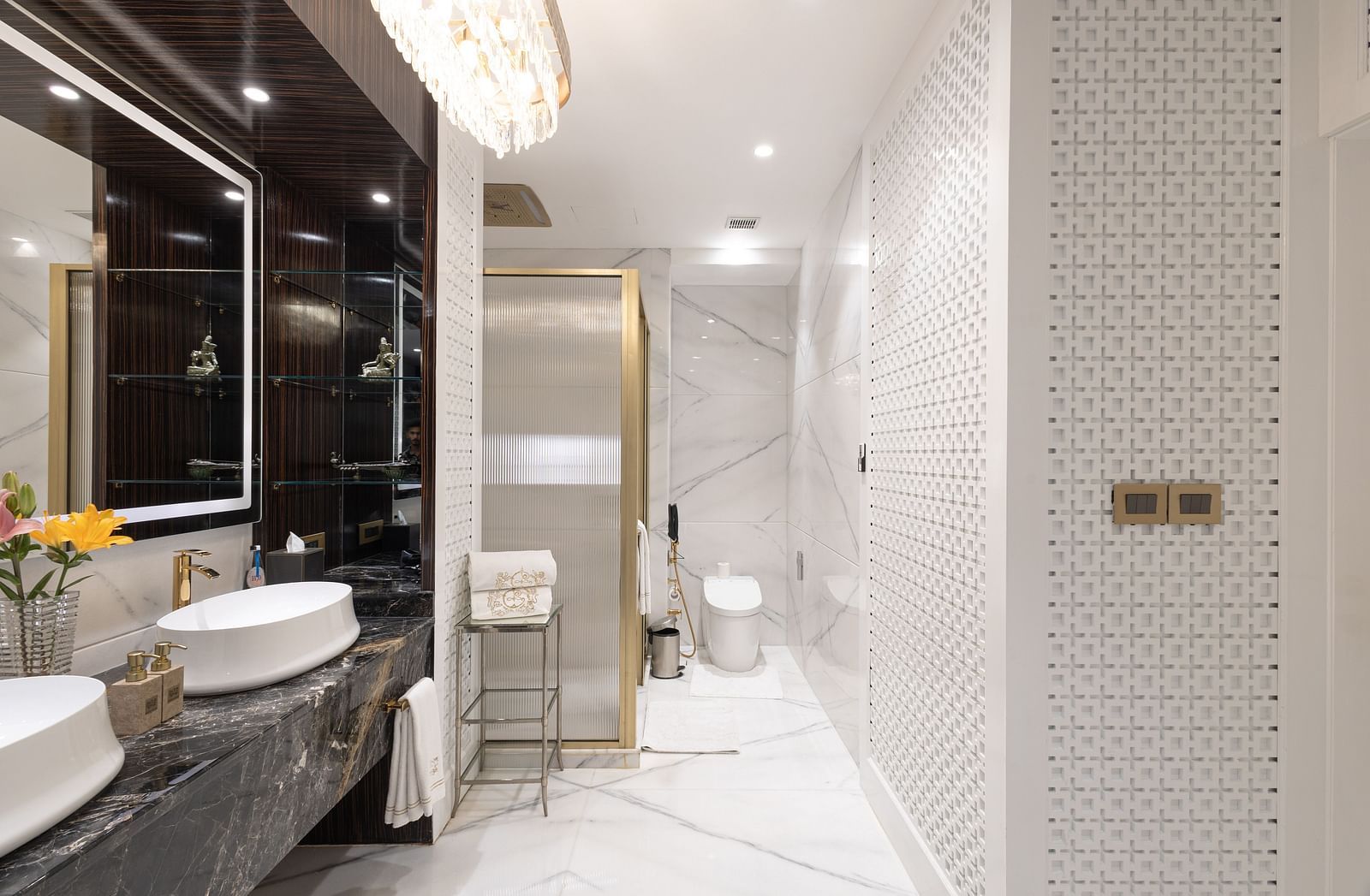Claridges Suite washroom at The Claridges New Delhi, showcasing sleek sinks, a wall-mounted mirror, and elegant lighting