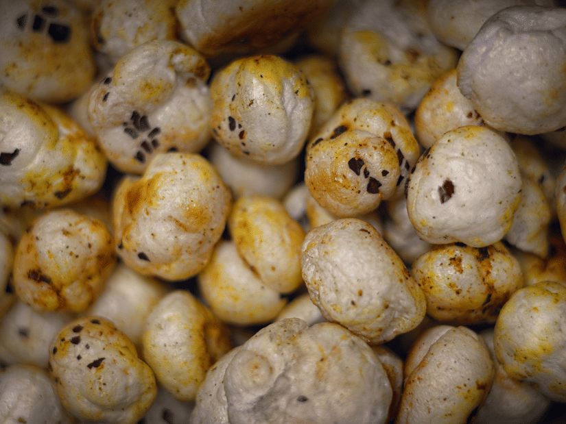 A close-up of a pile of puffed white makhana, or fox nuts