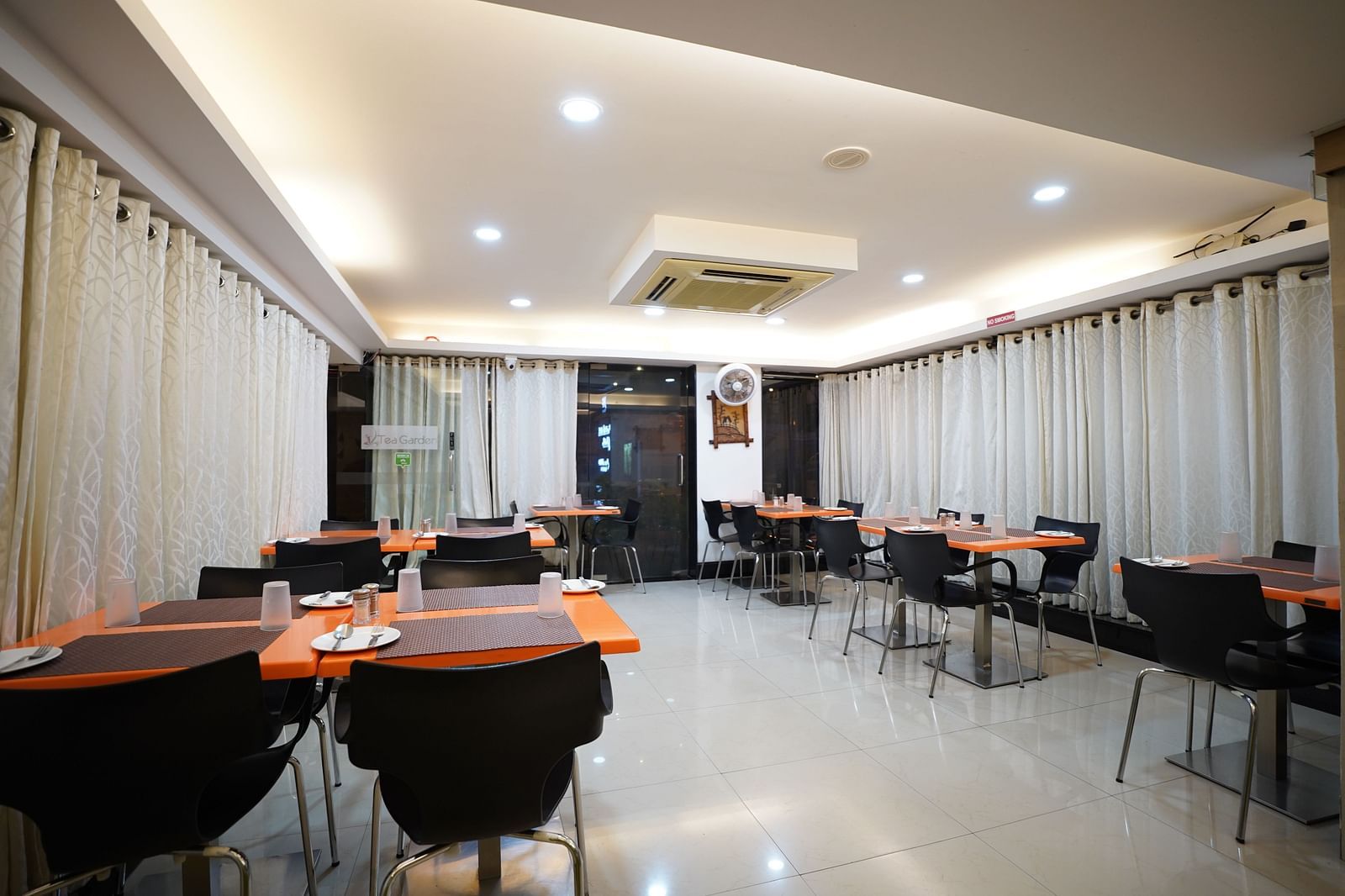 an image of a dining space with tables and chairs  at  City Centre Residency, Bangalore