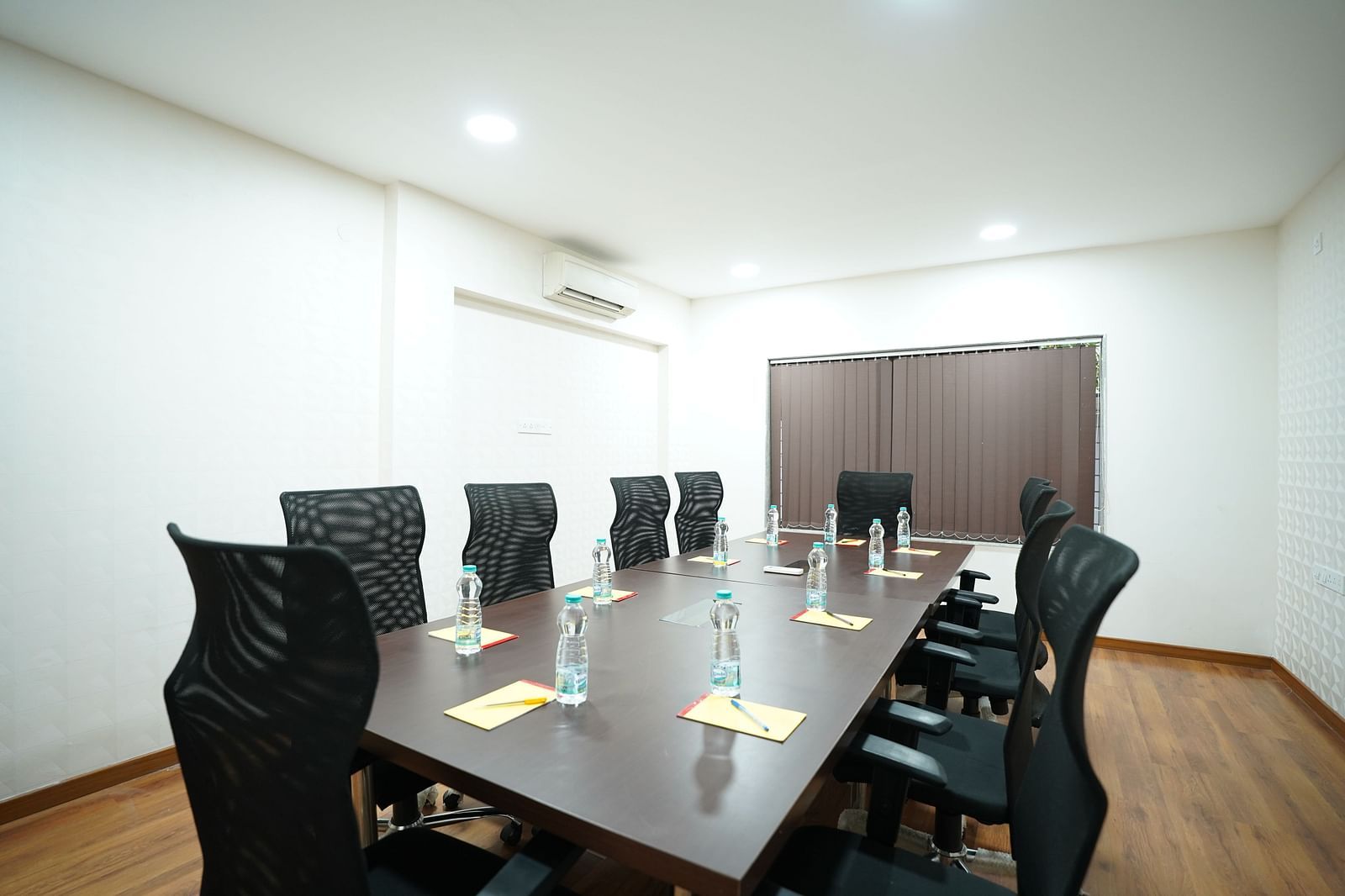 an image of a boardroom with a long wooden table and chairs at  City Centre Residency, Bangalore