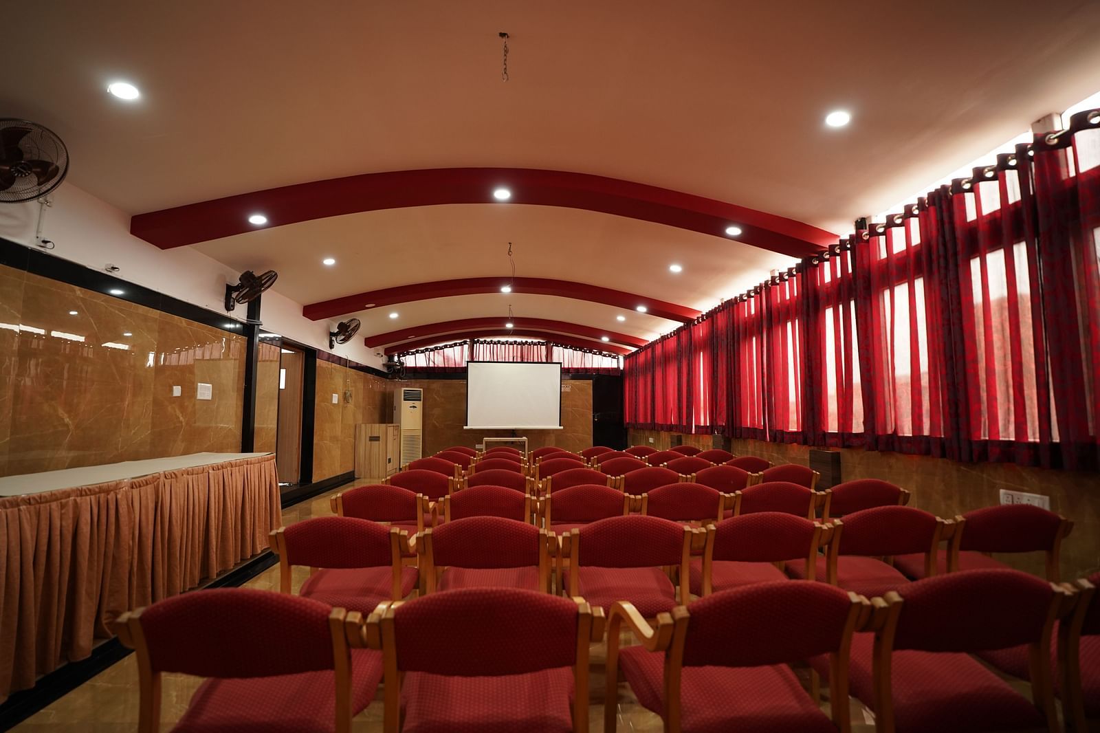 an image of an event space with chairs and a white screen to project  at  City Centre Residency, Bangalore