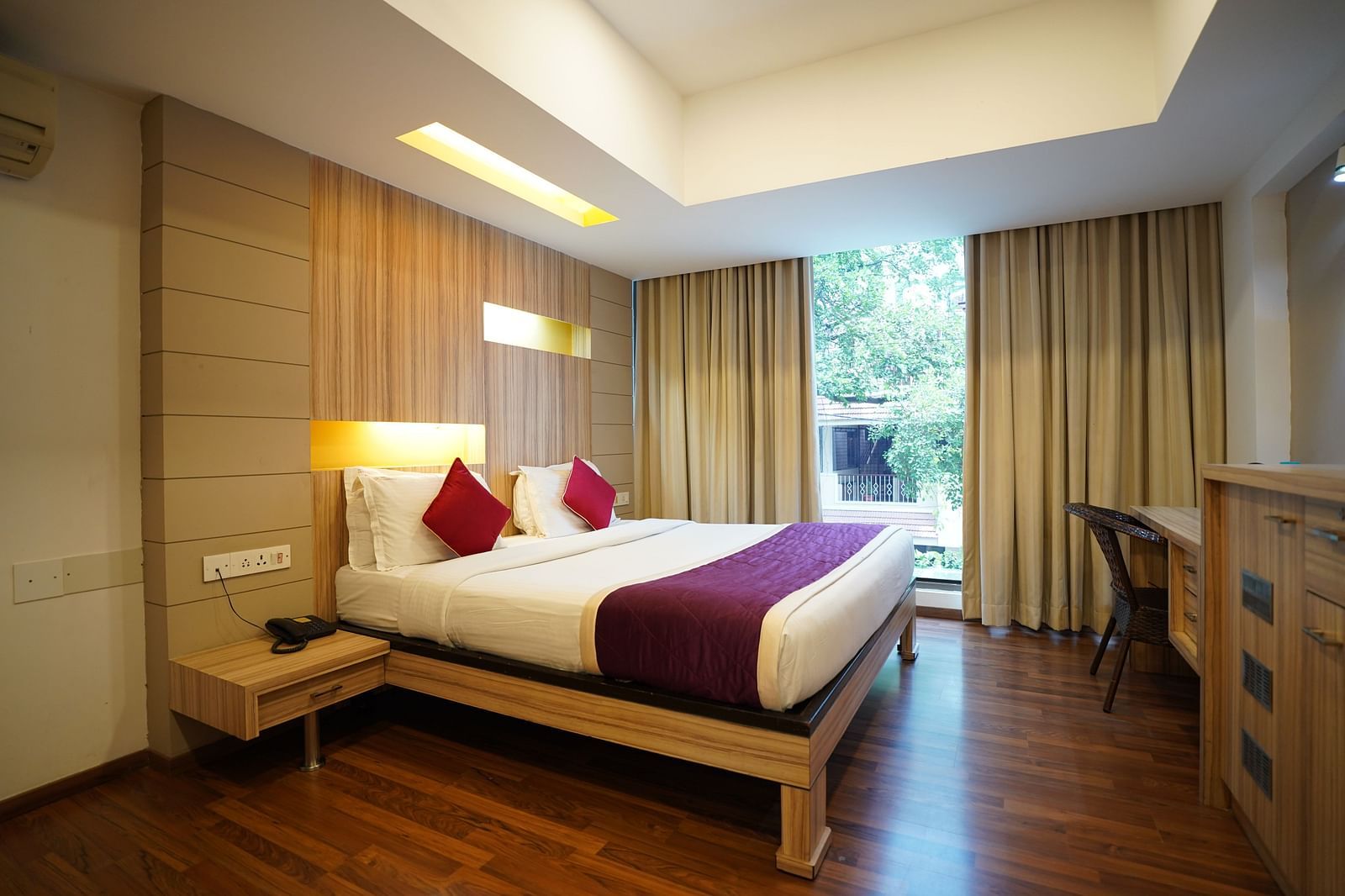 an image of a bed in a suite with a huge window at  City Centre Residency, Bangalore