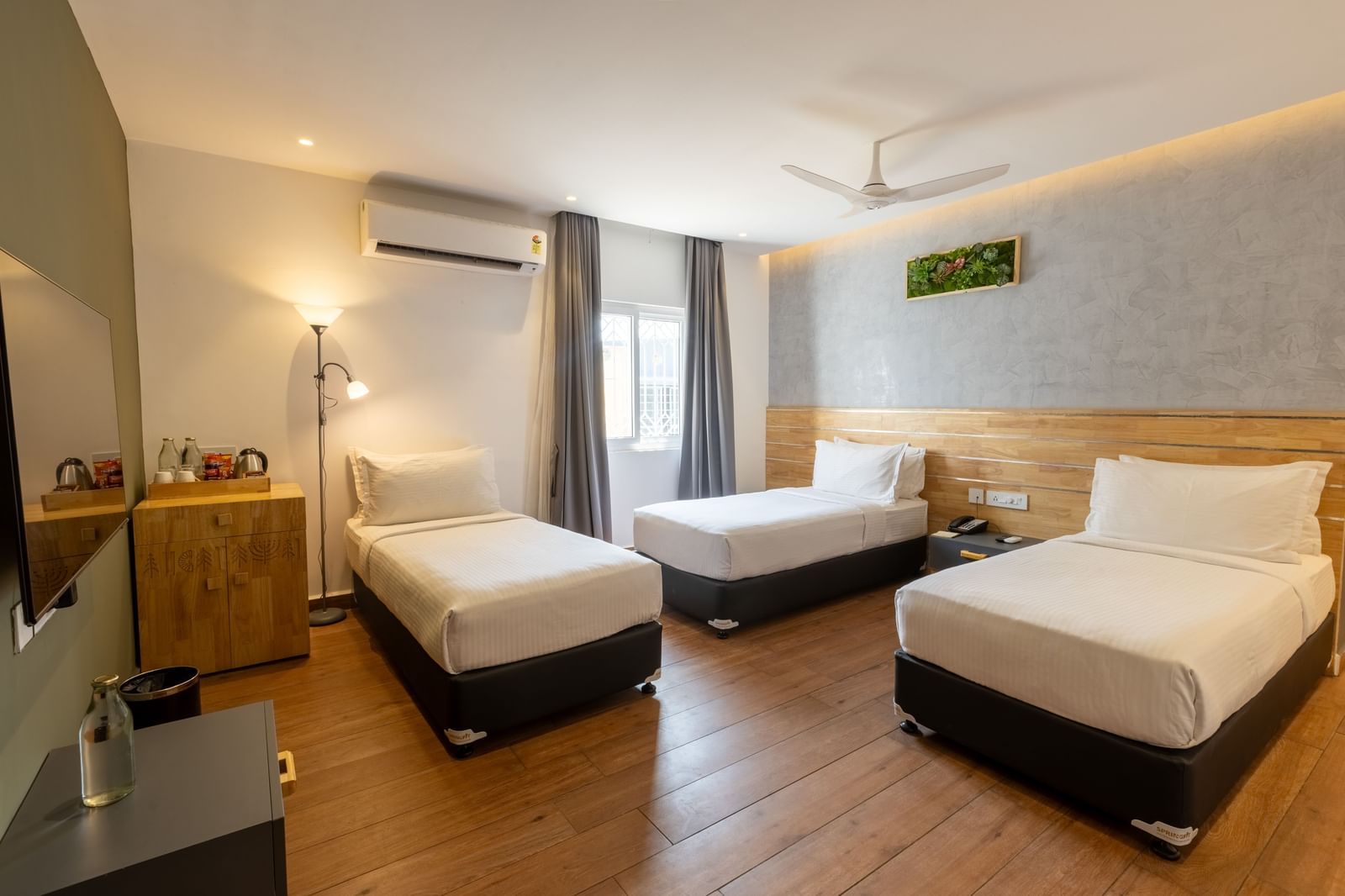 a bedroom with wooden flooring at the luxury group stay villa an ideal luxury group accommodation in Coimbatore at Darza Resorts