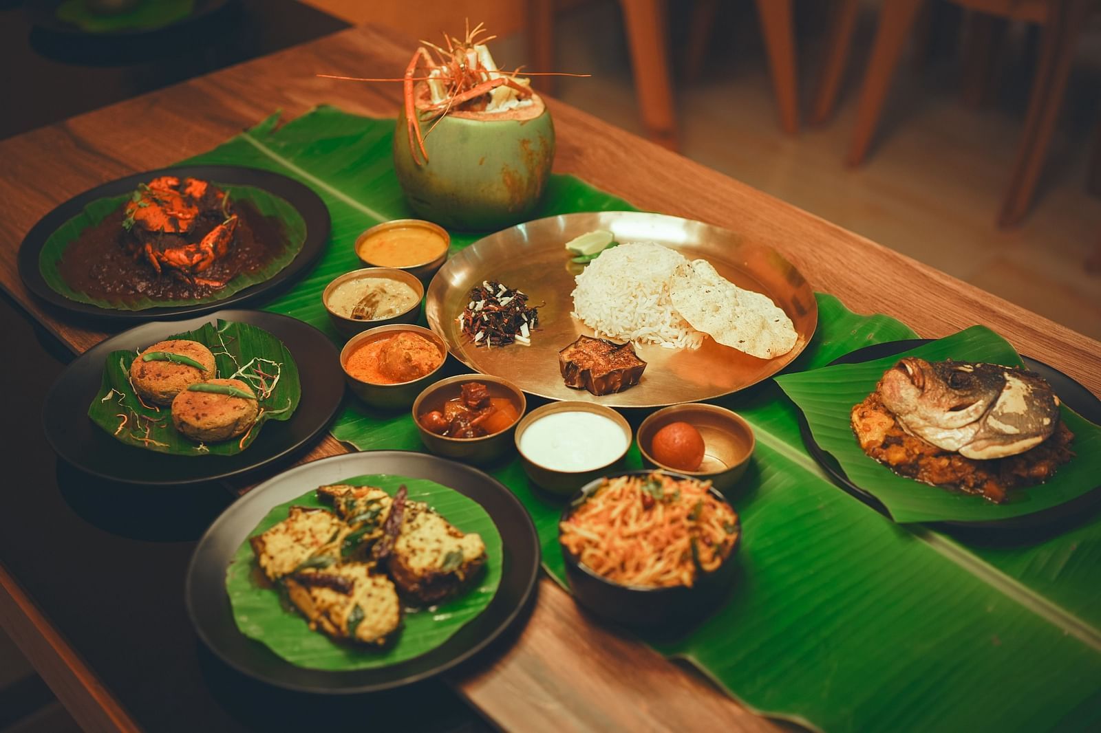 image featuring a beangli meal platter along with several bengali delicacies served on banana leaves - Dip Holidays, Birbhum