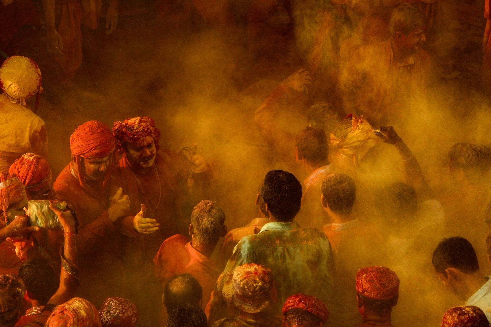 image of people playing with colours with a cloud of yellow colour floating in the air