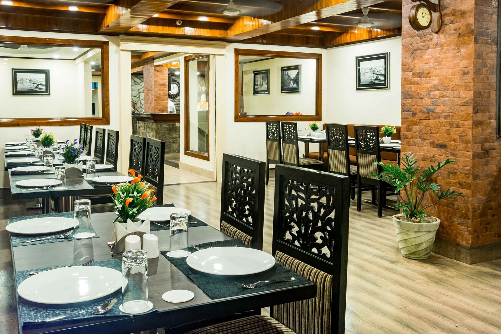 An image of a restaurant with seating arrangement and tables laid out with plates and cutlery - Ecotel Tin Tin, Bijanbari