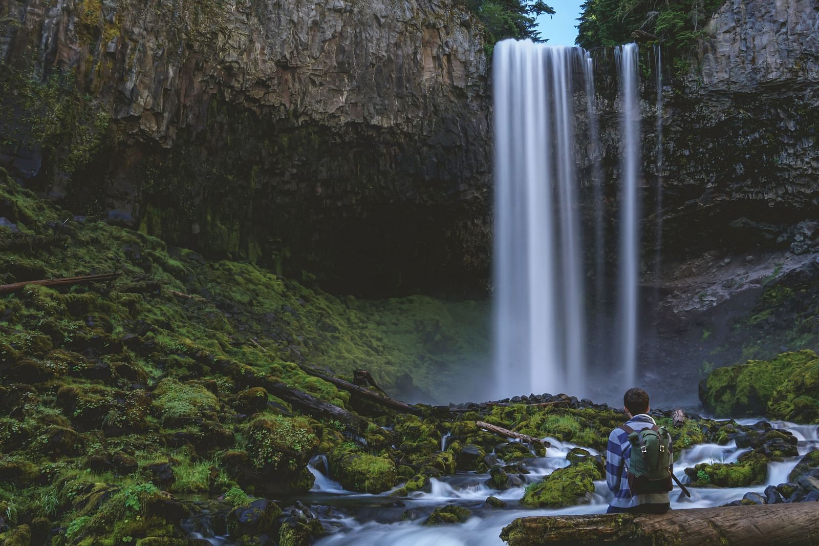 Wide view of a beautiful waterfall surrounded by greenery
