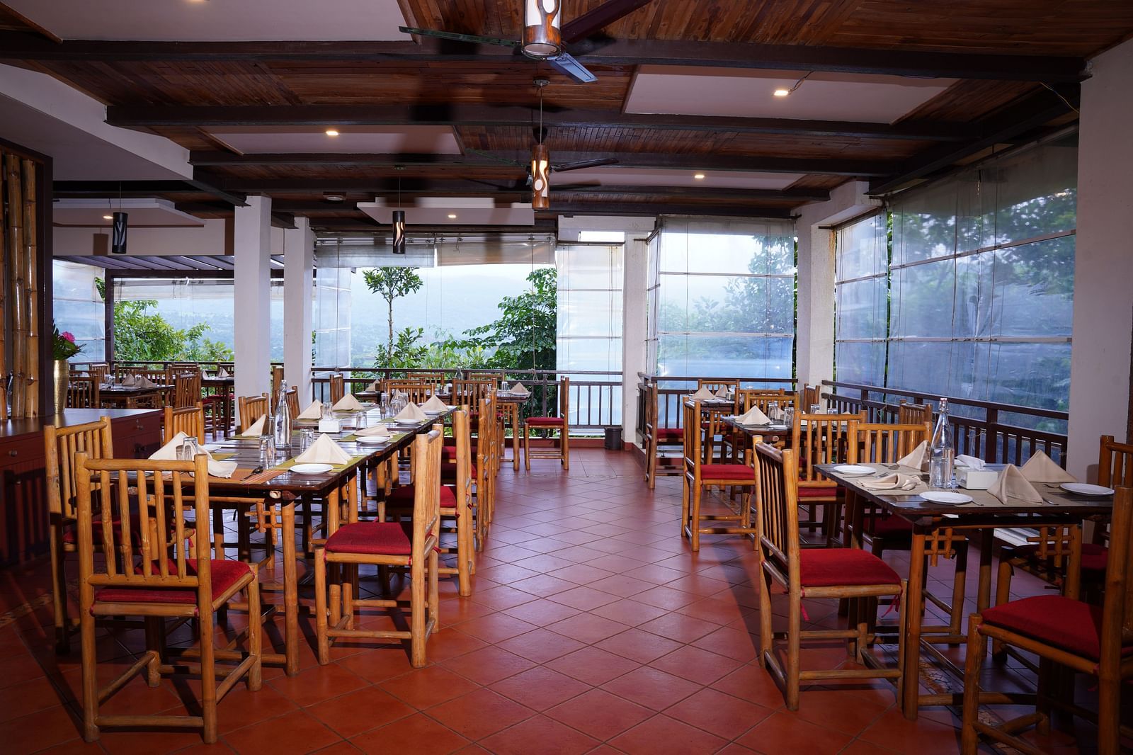 Another view of the dining space at Forest Escapes Koyna, showcasing the arrangement of tables and chairs.