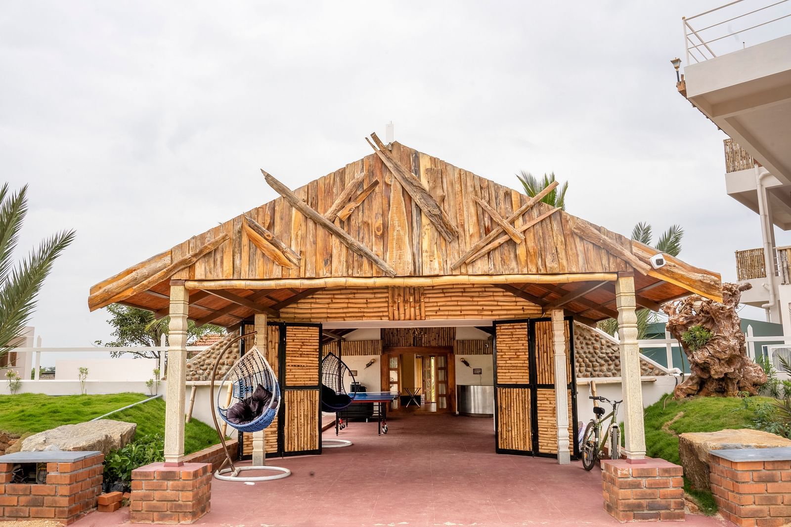 A Hut kind of property with swing and tables