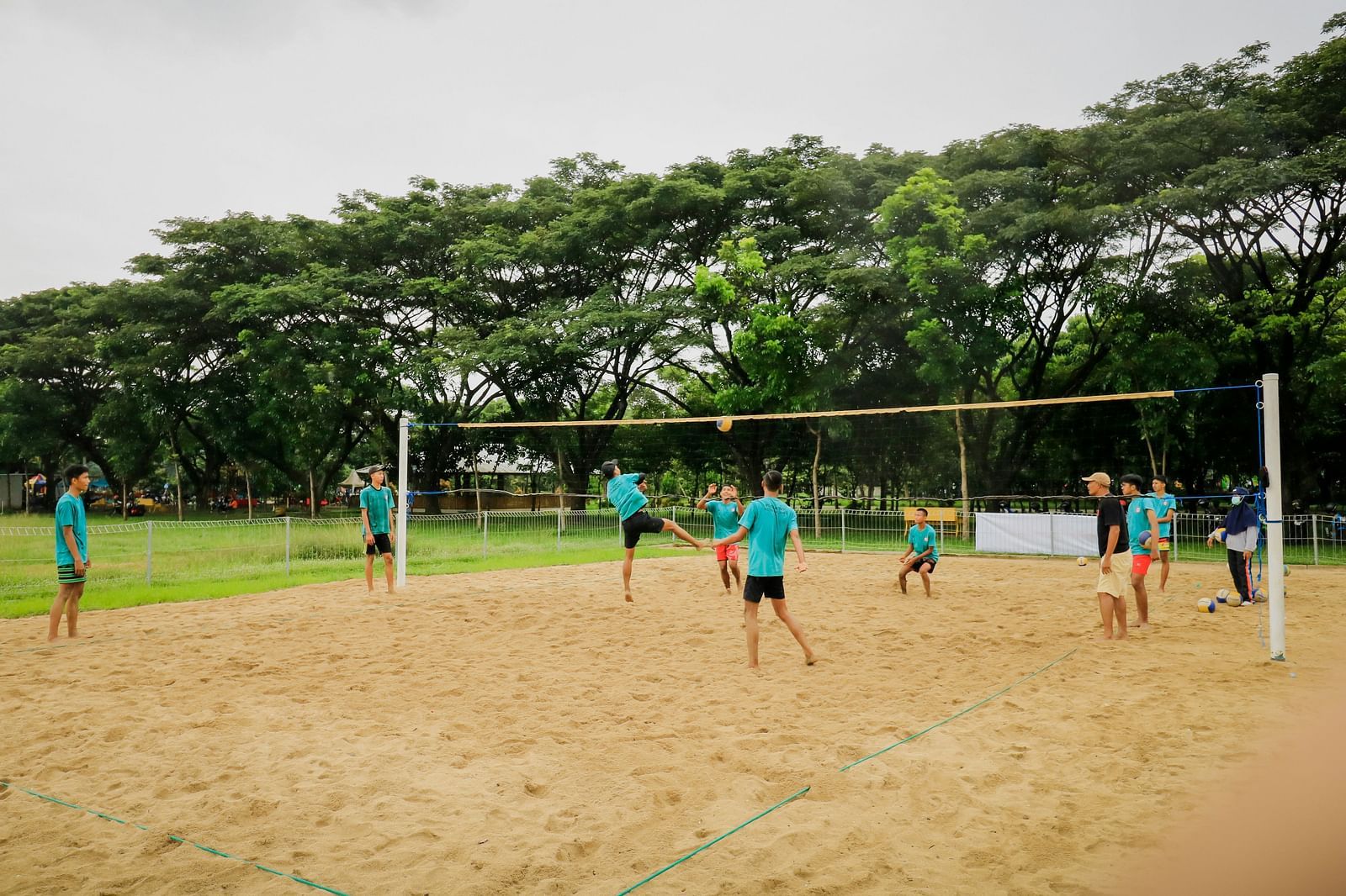 Image of a playground where people are playing volley ball
